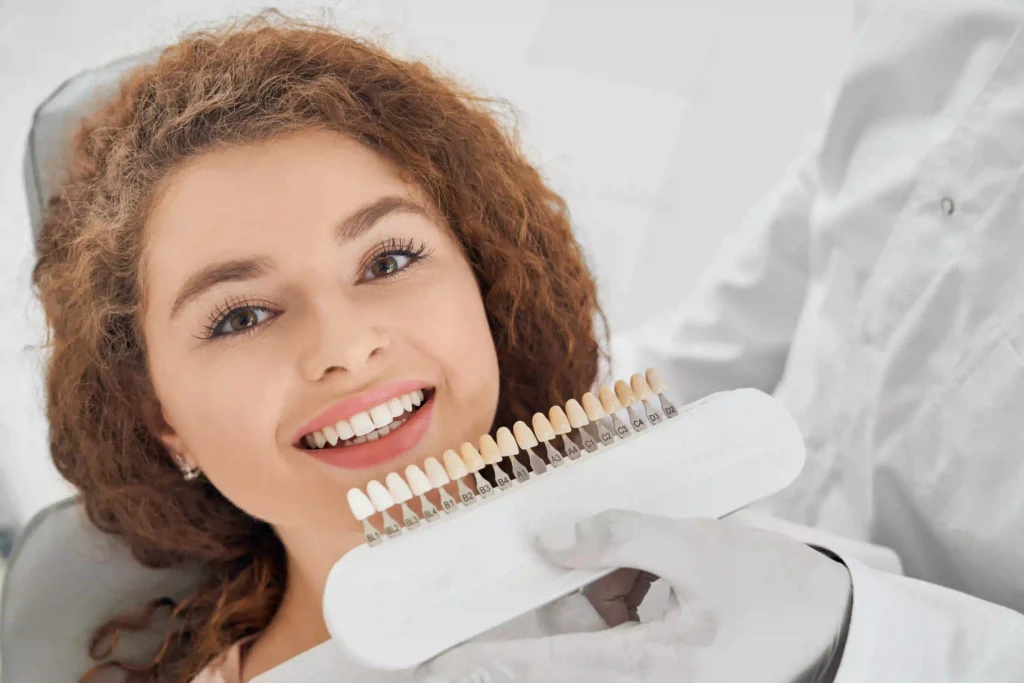Emergency Dentist in Bradford: What to Do If You Have Tooth Pain Today 1 woman smiling while male dentist keeping teeth color range ezgif.com optiwebp