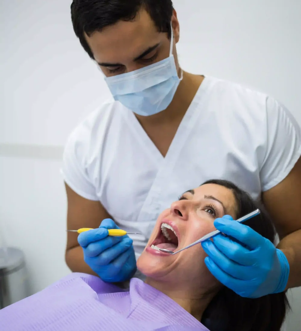 dentist-examining-female-patient-teeth-ezgif.com-optiwebp